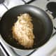 Pouting fillet in breadcrumbs in frying pan