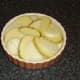 Potato and onion slices laid alternately in a baking dish