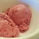 Two scoops of eggless raspberry ice cream. 