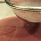 A strainer with a fine mesh will catch most raspberry seeds.