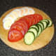 The hard boiled egg, tomatoes and cucumber are sliced as uniformly as possible