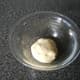 The kneaded dough is placed into a lightly oiled bowl, covered and left in a warm place to rise.