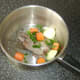 Quail, chopped vegetables and seasoning are added to a large pot