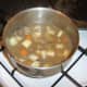 Chicken livers, vegetables and stock are added to a large stew pot