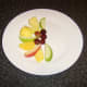 Fresh fruit of choice is arranged on a plate