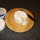 Wedges of camembert are cut to accompany the fresh fruit