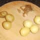 Cooked and cooled potatoes are skinned for roasting