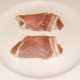 Partridge breasts are carefully wrapped in bacon