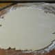 Flatten the dough out with your hands, then pick it up and turn it again.