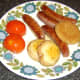 Sausages and sundries are transferred to warmed plate and covered with foil