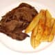 Steak and chips are plated first