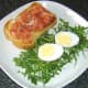 Smoked salmon and hard boiled duck egg are added to toast and salad