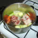Lamb bones are added to sauteed vegetables
