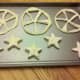 Use triangle cookie cutter or knife to cut out spokes of wheel. We also cut out star shaped biscuits with the scraps of the wheel.