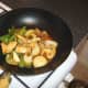 Sweet and sour sauce is added to chicken and vegetables
