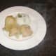 Chicken, pineapple and onion are plated alongside the rice