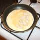 Chicken is added to half the almost set omelette