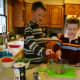 My two young sons add sage and salt to the chicken bullion.