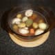 Lamb stock is poured in to casserole and it is ready for the oven