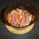 Sausages, beef and vegetables are added to casserole and seasoned