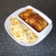 Naan bread is sliced and plated with the Jalfrezi chicken thighs
