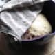 After the first proof - the dough is covered in a damp tea towel, and sits on a warm heater.