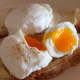 Poached eggs on buttered homemade brown soda bread is a delicious and healthy dish.