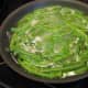 To parboil fresh beans, first cut off the ends of the beans, put them in the pan, and cover them with water. Put the heat on and boil for 5 minutes. Get an adult to help you pour off the water. Then put the green beans aside and follow the recipe.