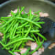 Step 5: Take the green beans out of the microwave, cut open the bag (be careful of the steam!), and then pour them into the pan with the turkey bacon.