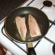 mackerel fillets are laid in the pan skin side down