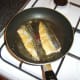 Mackerel fillets are turned at the last minute to complete cooking on the flesh sides