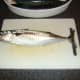Mackerel is laid flat on a chopping board