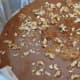 Toffee in pan, with walnuts sprinkled over it.