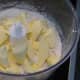 Adding chopped cold butter to the mixed dry ingredients.