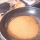 Sugar tipped into hot pan with 2 TBsp butter. Stir continuously with a metal spoon.