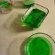 The Jell-O will look a normal green color in regular light.
