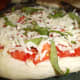 Add mozzarella cheese and some more basil for the final layer.