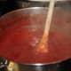 Crushed tomatoes cooking with garlic salt, Italian seasonings, pepper and white onions.