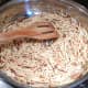 Place fideo (vermicelli) in a skillet and stir fry until brown over medium heat. (grease the skillet with 1 tablespoon of canola oil)