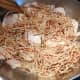 Add the browned fideo (vermicelli) over the cooked chicken.