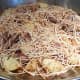 Add browned fideo (vermicelli) over the browned stew meat, onions, and potatoes.