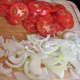 Sliced onions, red bell peppers, tomatoes and bit of bacon.