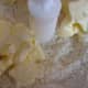 Adding the butter to the flour mixture.