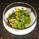 Salad is tossed with salt and pepper