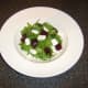 Beetroot and feta cheese are added to bed of green salad leaves