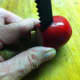Insert the tool into the radish and push half way through.