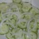 Sliced cucumbers and onion layered.