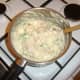 Carefully combining the fish pie filling ingredients