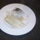 Poached fish is removed from milk