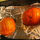 The pumpkins will become soft and can be pierced with a butter knife when they are done cooking.